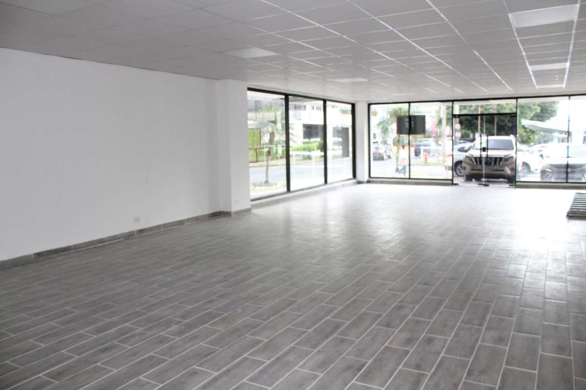 Empty office or retail space with floor-to-ceiling windows and gray tiled floors in Panama