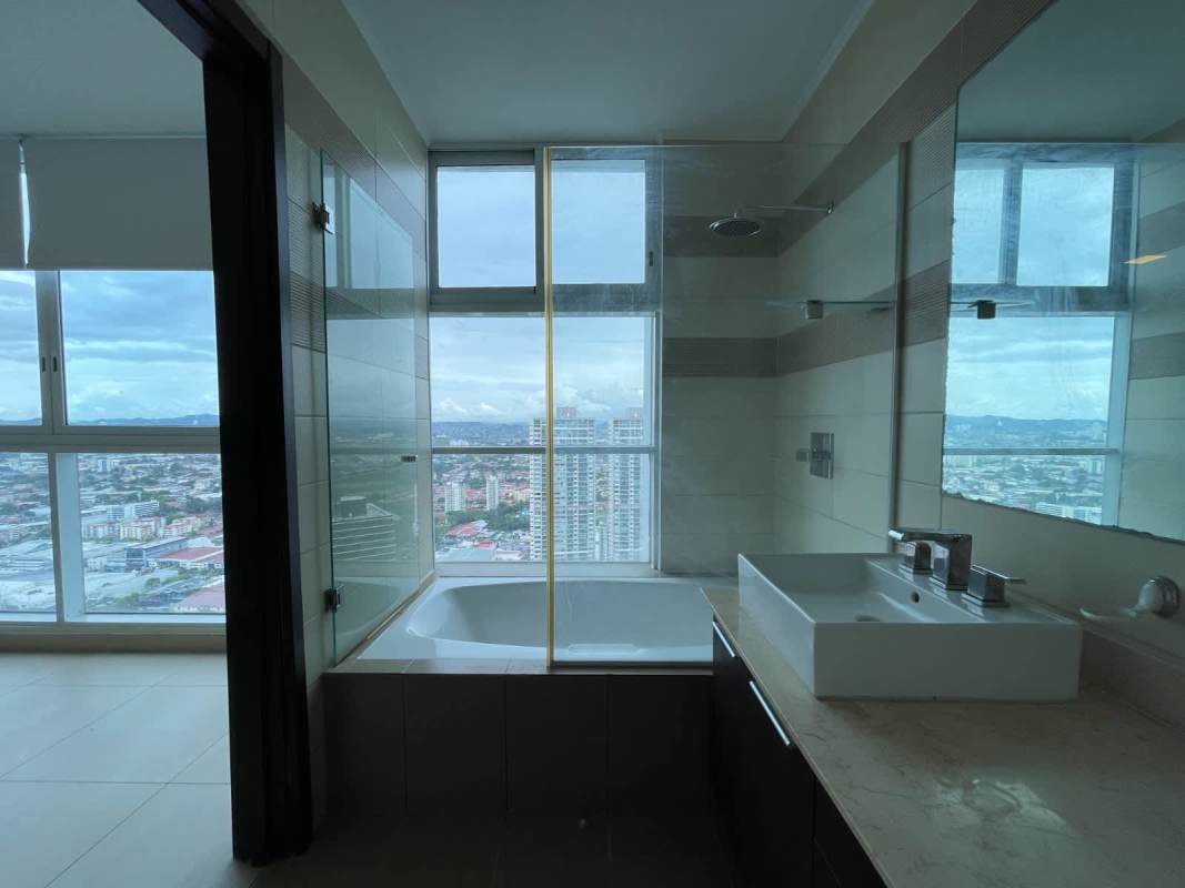 Modern bathroom featuring glass enclosed shower and city skyline view in The Regent Costa del Este Panama