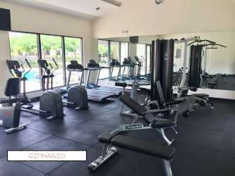 Gym with modern equipment overlooking pool at River Valley Panama Pacifico