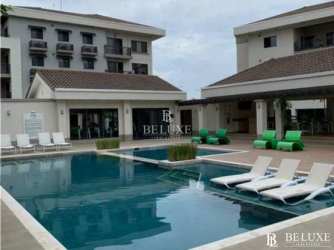 Poolside lounge chairs and patio at PH River Valley Panama Pacifico