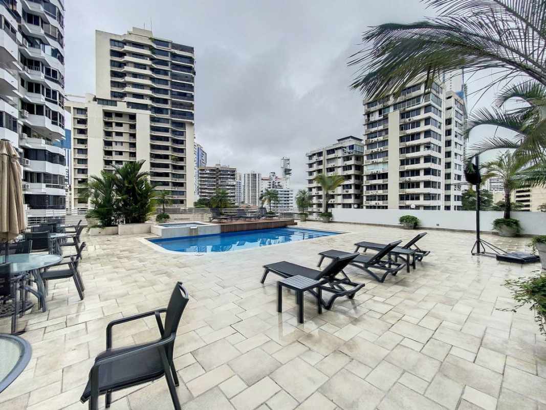 Bright open-plan living room with large windows and ocean skyline view in Marbella Panama