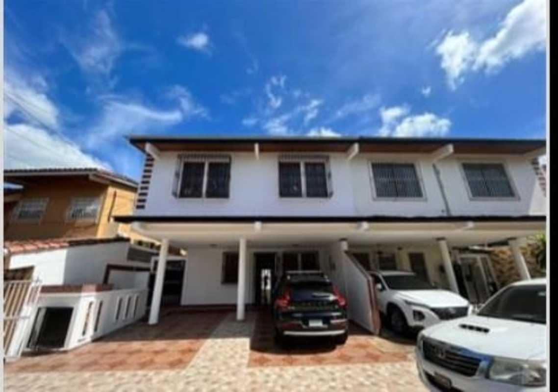 Two-story house exterior with gated driveway and carport in Bethania Panama