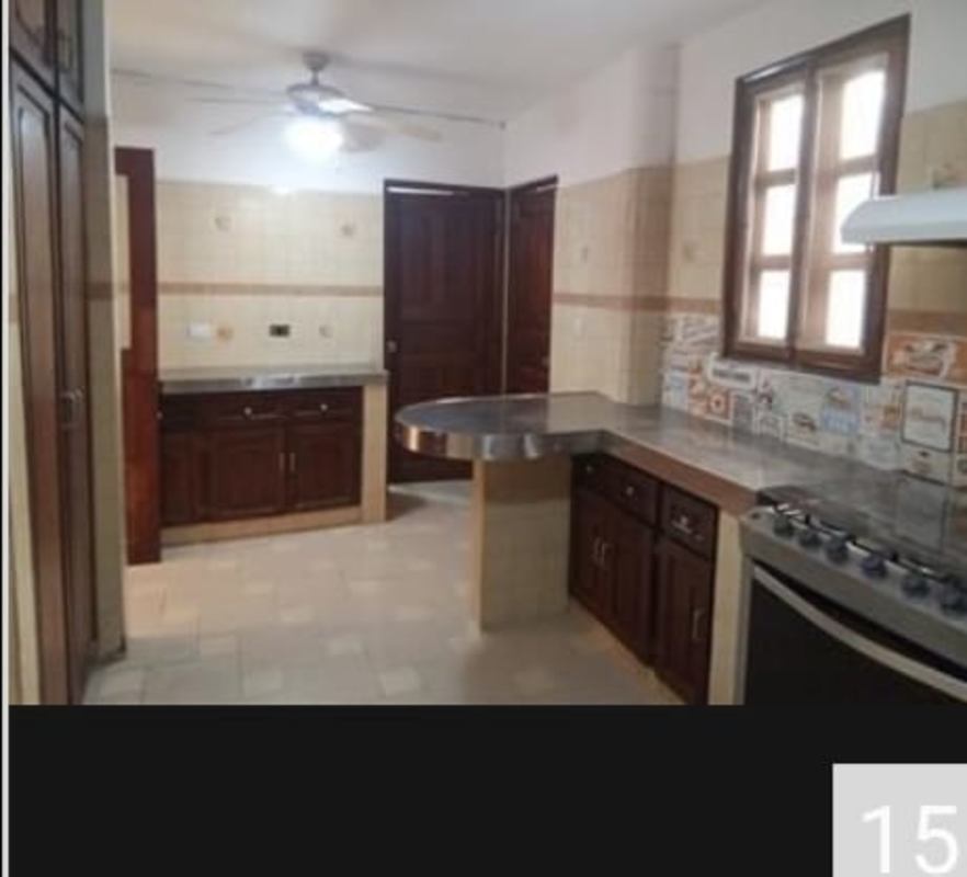 Traditional kitchen wooden cabinets stainless counters tiled backsplash Bethania house