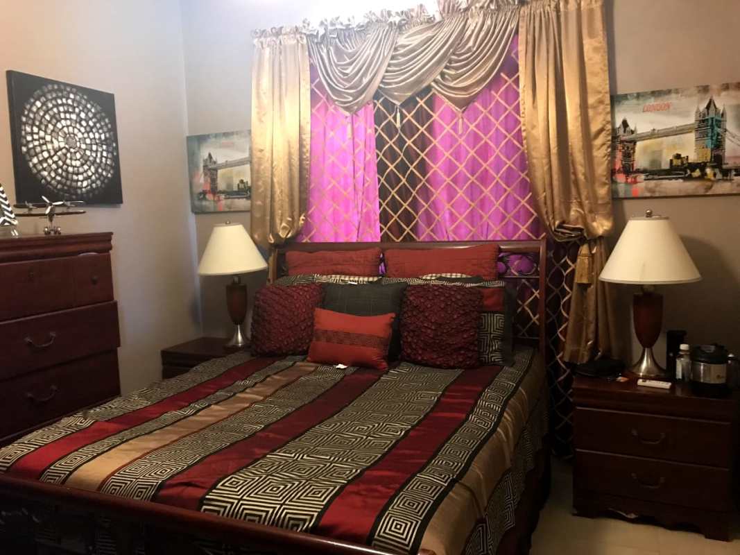 Elegant bedroom gold purple curtains double bed Panama City Costa Sur home