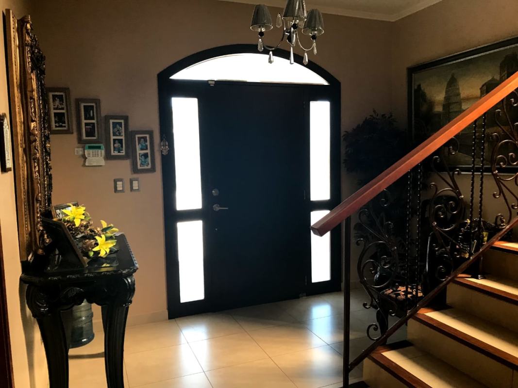 Traditional entryway with iron staircase marble floors luxury Costa Sur house Panama City