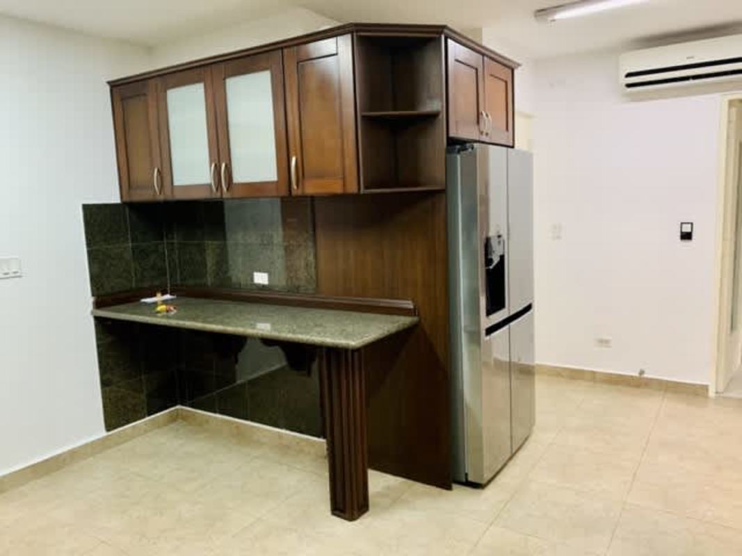 Living room with tiled floors, large windows, sliding doors with security bars in Clayton rental house