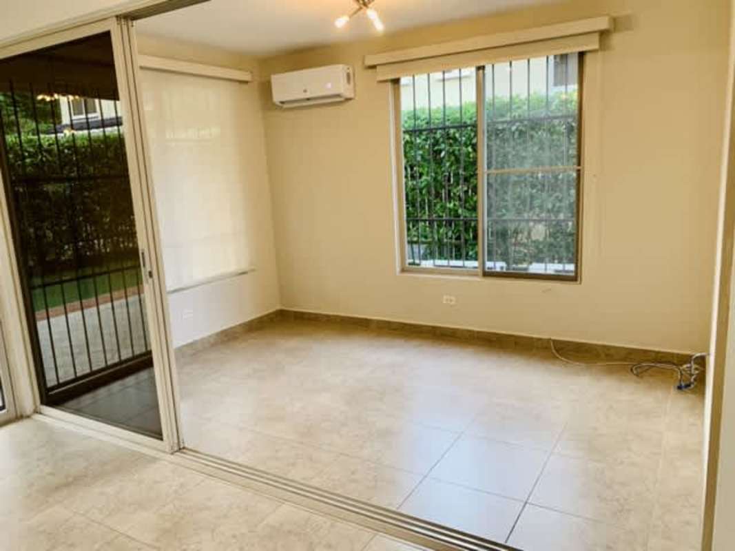 Bright bedroom with built-in closets and large windows in Clayton rental house