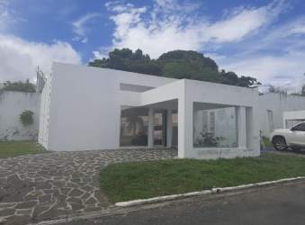 Modern white beach house with large windows and stone pathway at Ibiza Beach Residence Panama