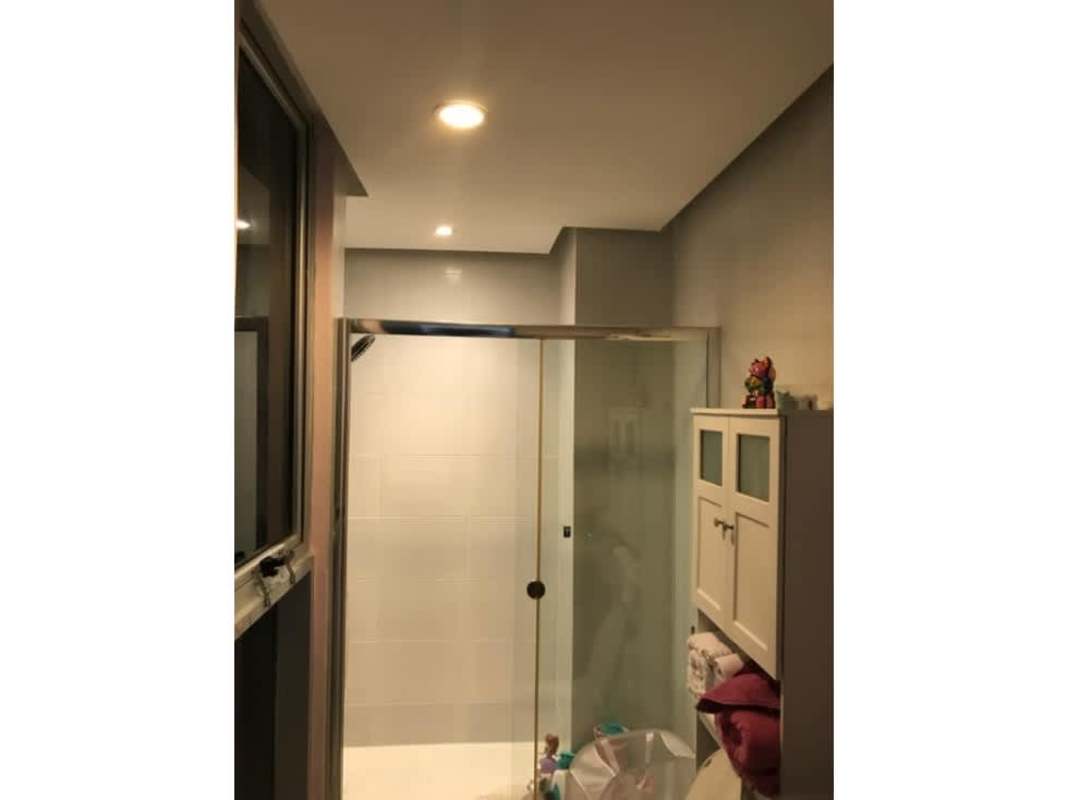 Bright open living area with tile floors next to ocean-view balcony PH Waterfalls in Coco del Mar Panama.