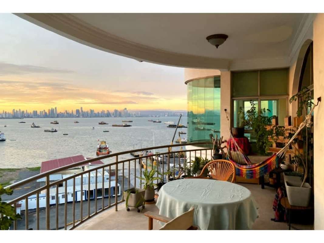 Elegant dining room with panoramic window, ocean and city views PH Amador Heights Panama City
