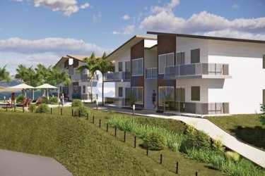 Modern low-rise apartments with balconies, palm trees and garden at Bougainvillea Villas near Playa Venao Panama