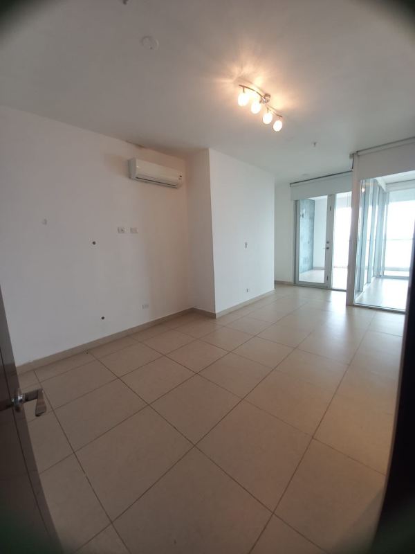 Bright open living room with ocean view windows and balcony access in PH BICSA Avenida Balboa Panama