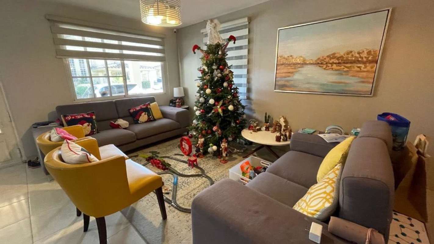 Bright modern living room decorated for holidays large windows in duplex house The Springs Condado del Rey