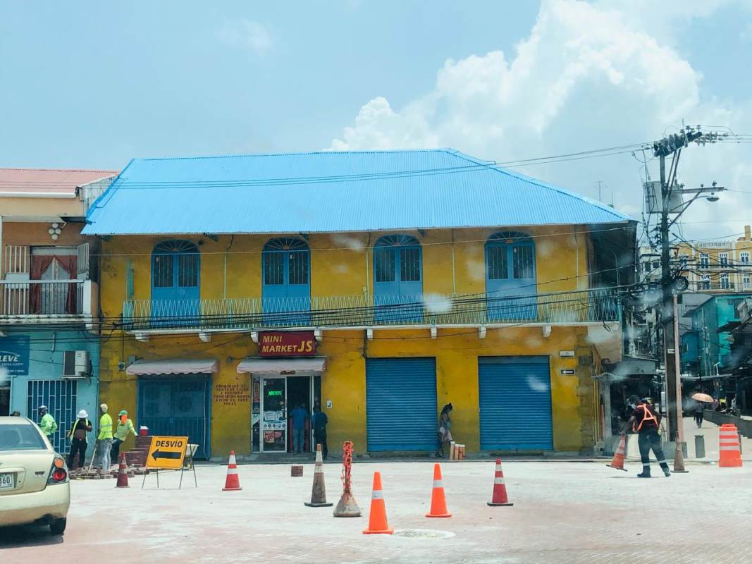 Two-story yellow colonial building with balconies and blue shutters prime retail location Casco Viejo Panama