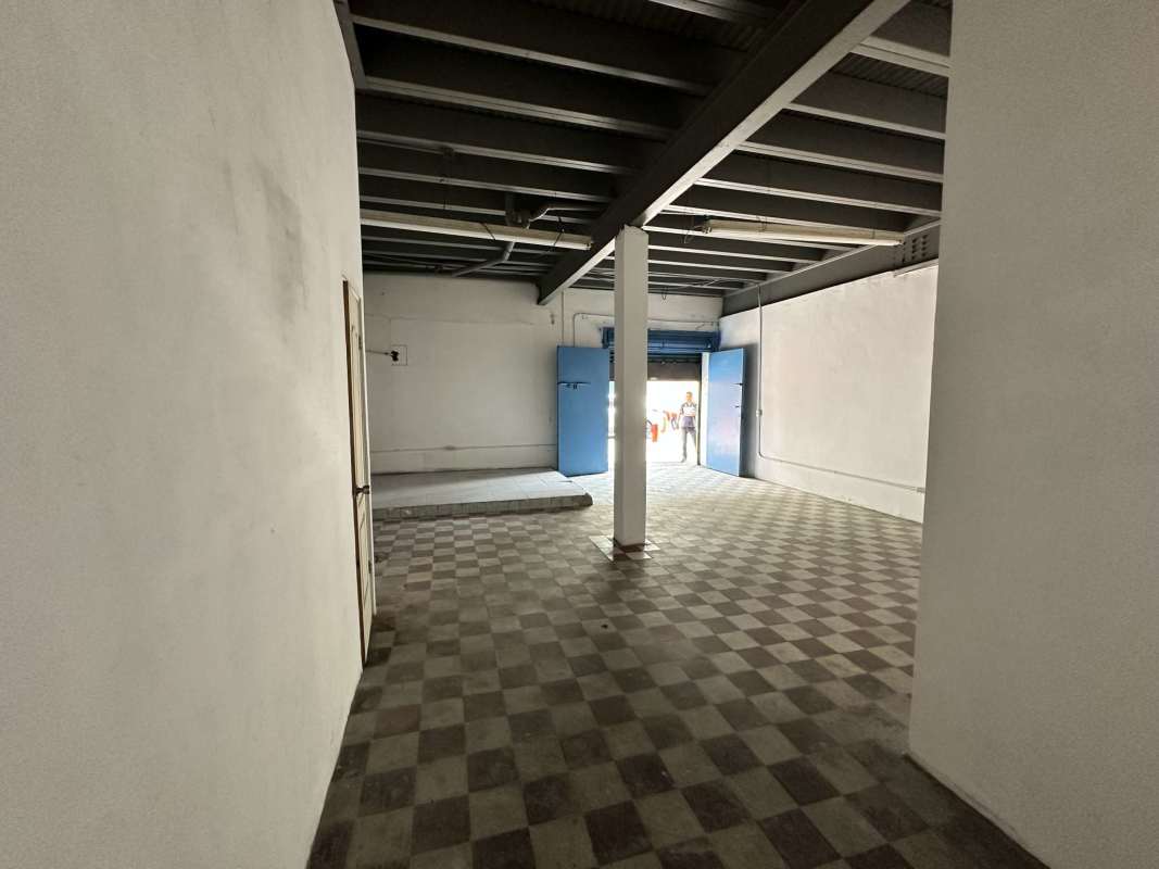 Industrial warehouse interior with tile floors large doorway beams colonial style Panama City