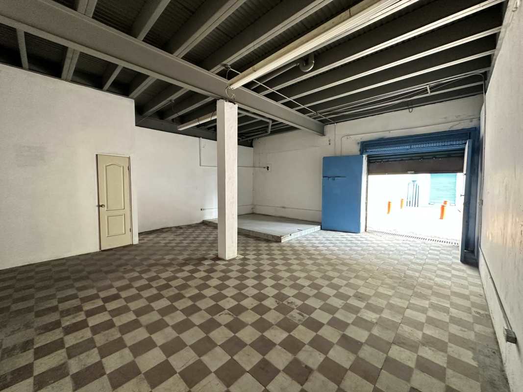 Industrial style commercial interior with checkered tile floor and exposed beams in Casco Viejo Panama