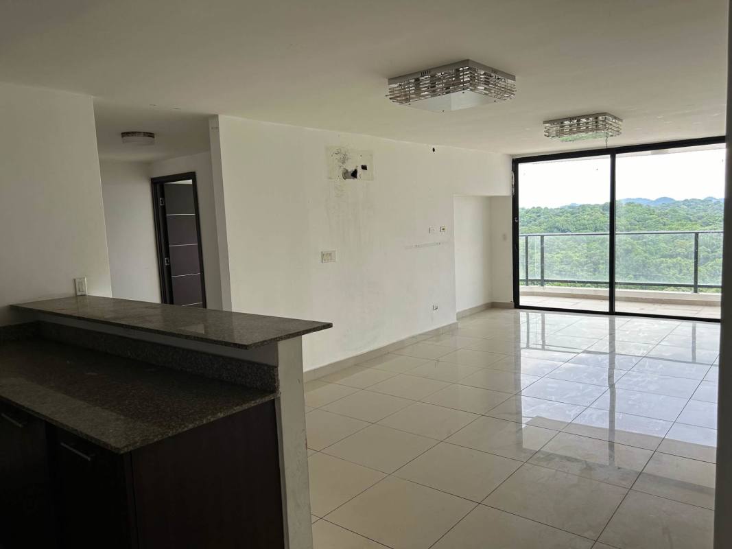 Modern open-plan living-dining area with granite kitchen counter and balcony view PH Portofino Tower Bethania Panama