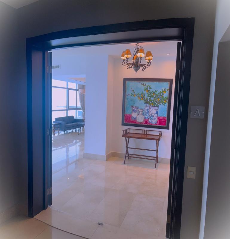 Primary bedroom with panoramic windows walk-in closet marble floors PH Ten Tower Costa del Este Panama