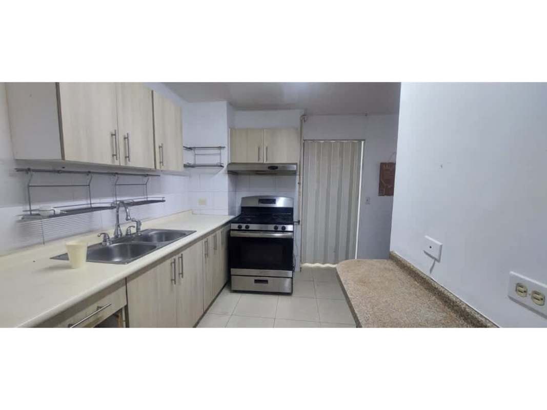 Kitchen with granite countertop light wood cabinets double sink at PH Victory Tower Panama
