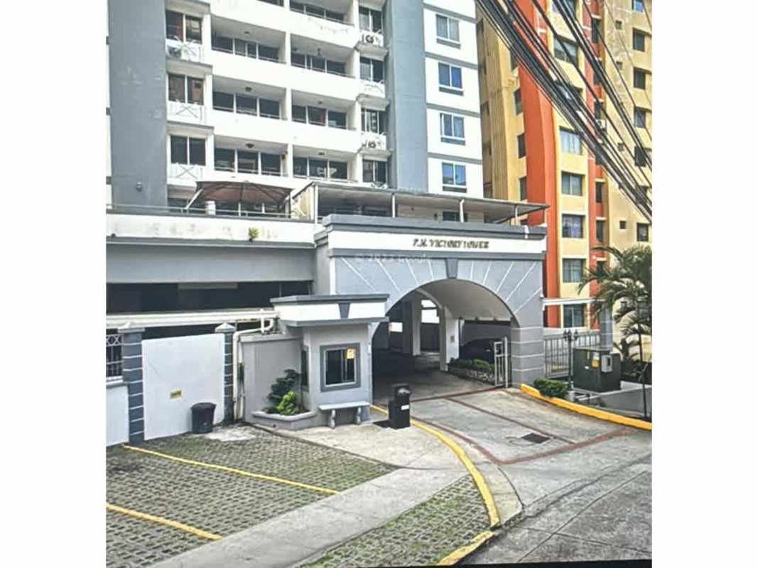 Exterior view multi-story building arched driveway entrance PH Victory Tower Panama City