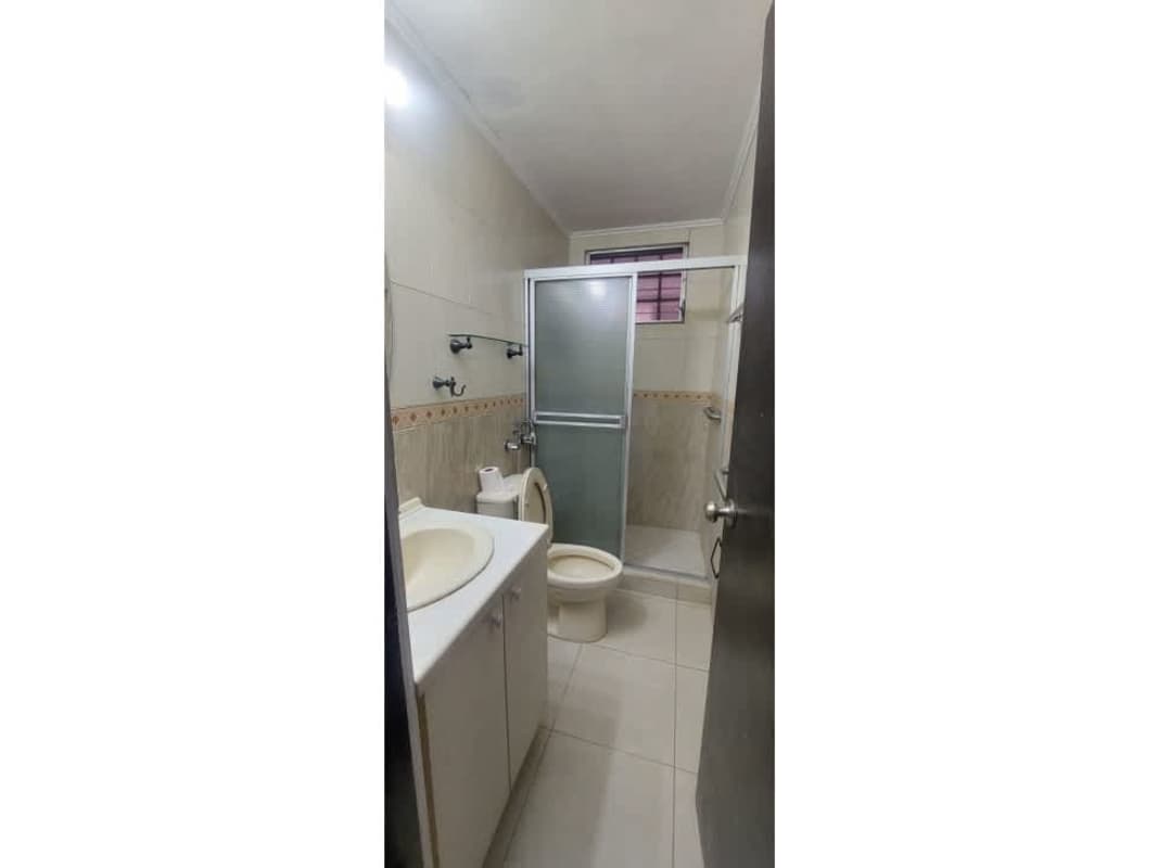 Bathroom with walk-in shower curtain and wall mirror at PH Victory Tower Panama