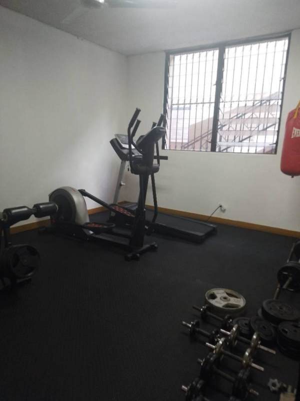 Dedicated home gym area with equipment treadmill, rowing machine at PH La Cresta Panama City