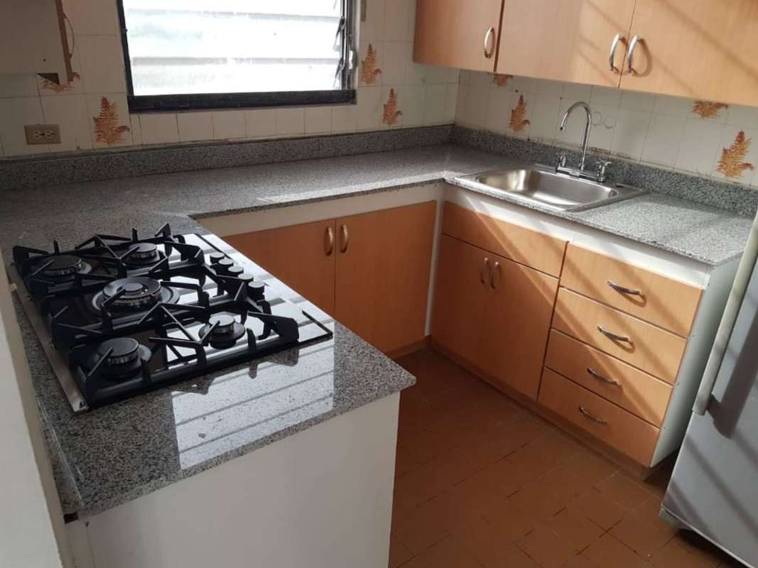 Small kitchen with gas stove granite countertop window PH La Cresta El Cangrejo Panama