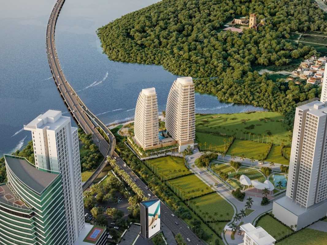 Modern luxury high-rise twin towers by waterfront with lush greenery