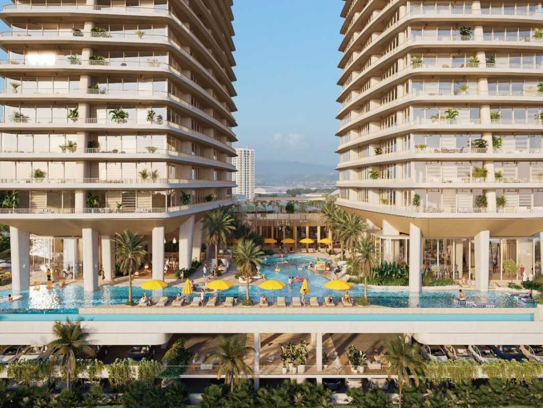 Large swimming pool deck with city skyline in background at IPANEMA