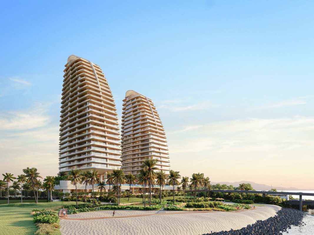 Modern twin high-rise beachfront buildings with palm landscaping in Costa del Este