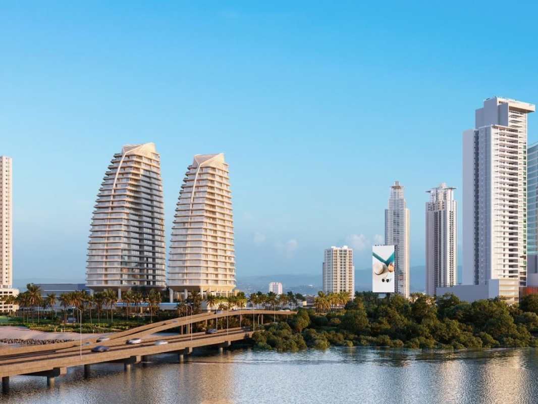 Modern skyscrapers on oceanfront with curved design and bridge access at Costa del Este