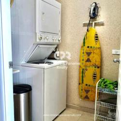 Laundry room equipped with stacked washer dryer unit in Coronado Bay apartment Panama