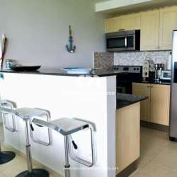 Kitchen with granite countertop mosaic backsplash and stainless appliances at PH Coronado Bay