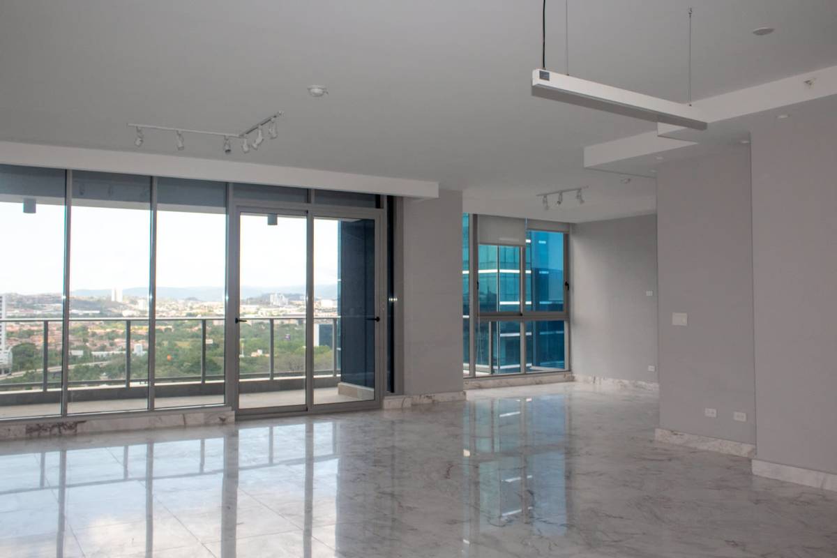 Spacious living room with marble flooring, floor-to-ceiling glass windows, and panoramic city view in PH Regalia Costa del Este Panama