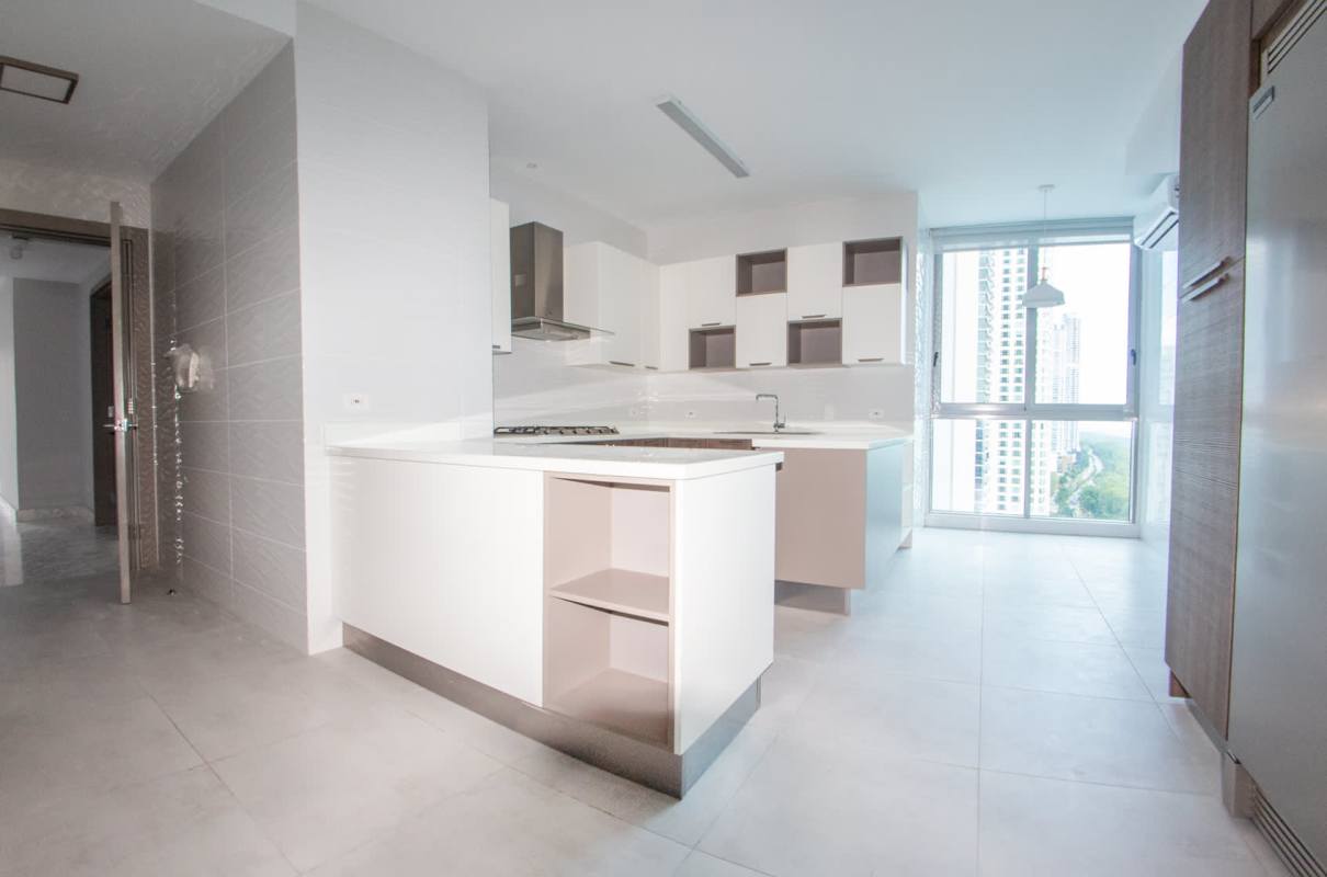 White modern kitchen with large windows offering city views in PH Regalia Costa del Este