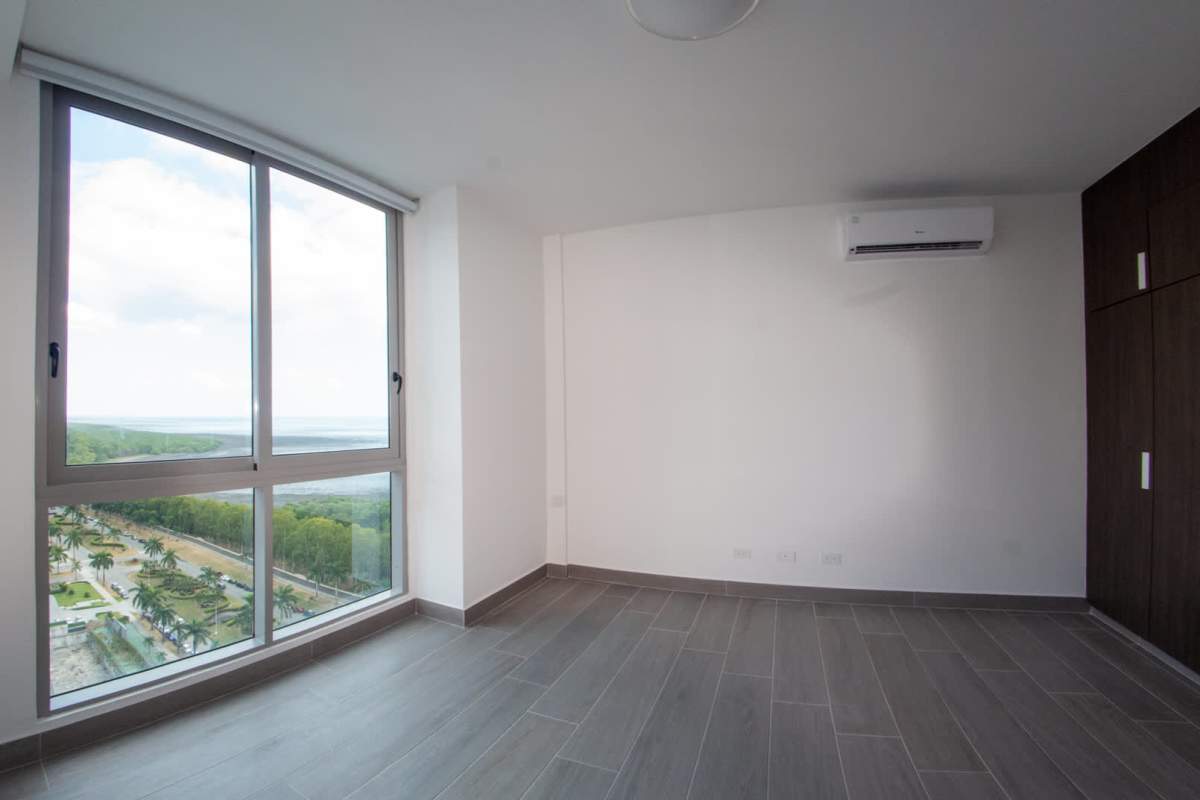 Spacious modern bedroom featuring large window with city and nature views, built-in wardrobe, AC in PH Regalia Panama