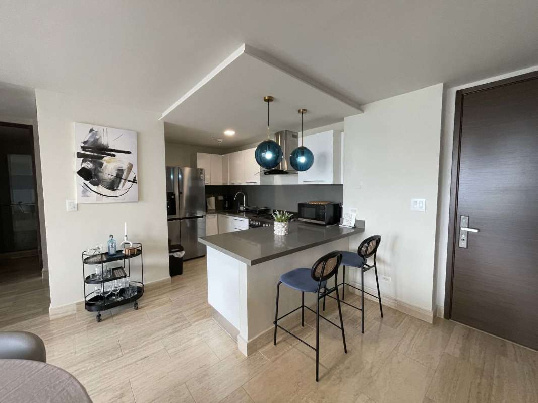 Infinity pool with ocean view and lounge deck at Costa del Este Executive Tower Panama City