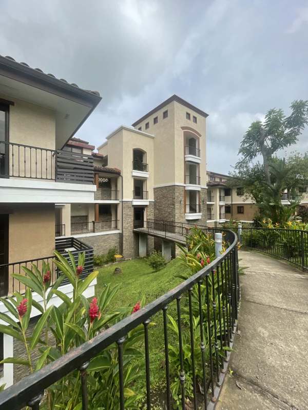 Large living and dining area with tile flooring balcony access Embassy Club Clayton Panama