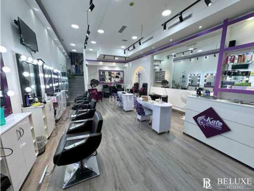 Reception desk with salon chairs, product shelves and modern lighting Plaza 68 San Francisco Panama
