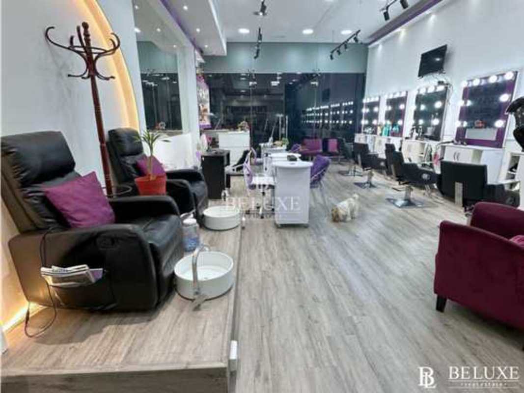 Modern salon with styling stations, pedicure seats, lighting and large mirrors at Plaza 68 San Francisco