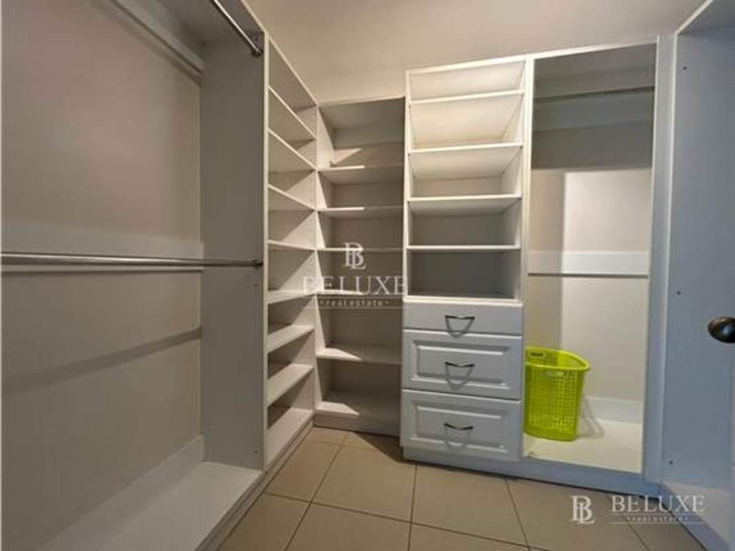 Elegant bathroom with marble counters, double sinks and glass shower in PH Sol Marina Panama