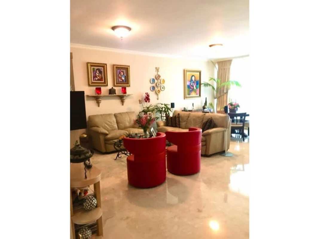 Kitchen with granite countertops, wooden cabinetry, large window PH Bahía Esmeralda Marbella Panama City