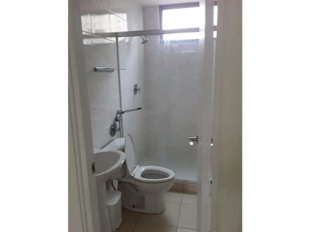 Modern bathroom with glass shower partition and pedestal sink in PH Deluna Park View Panama