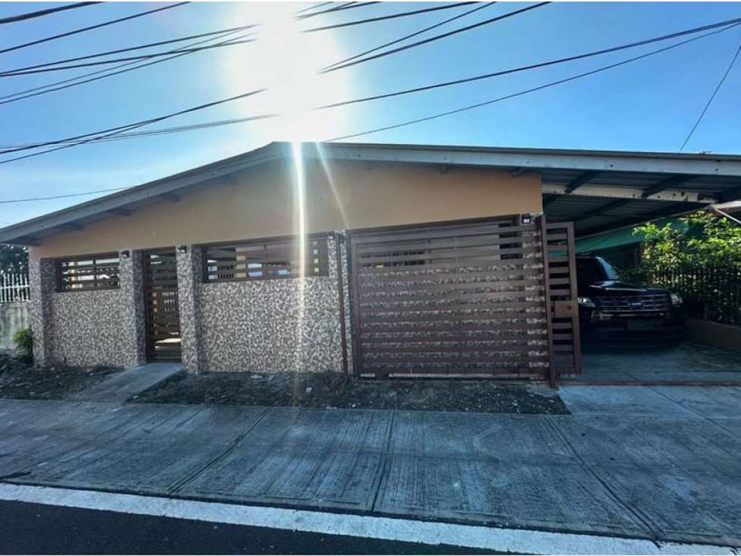 Stone façade, metal gate and covered carport with vehicle at spacious house Ciudad Radial Juan Díaz
