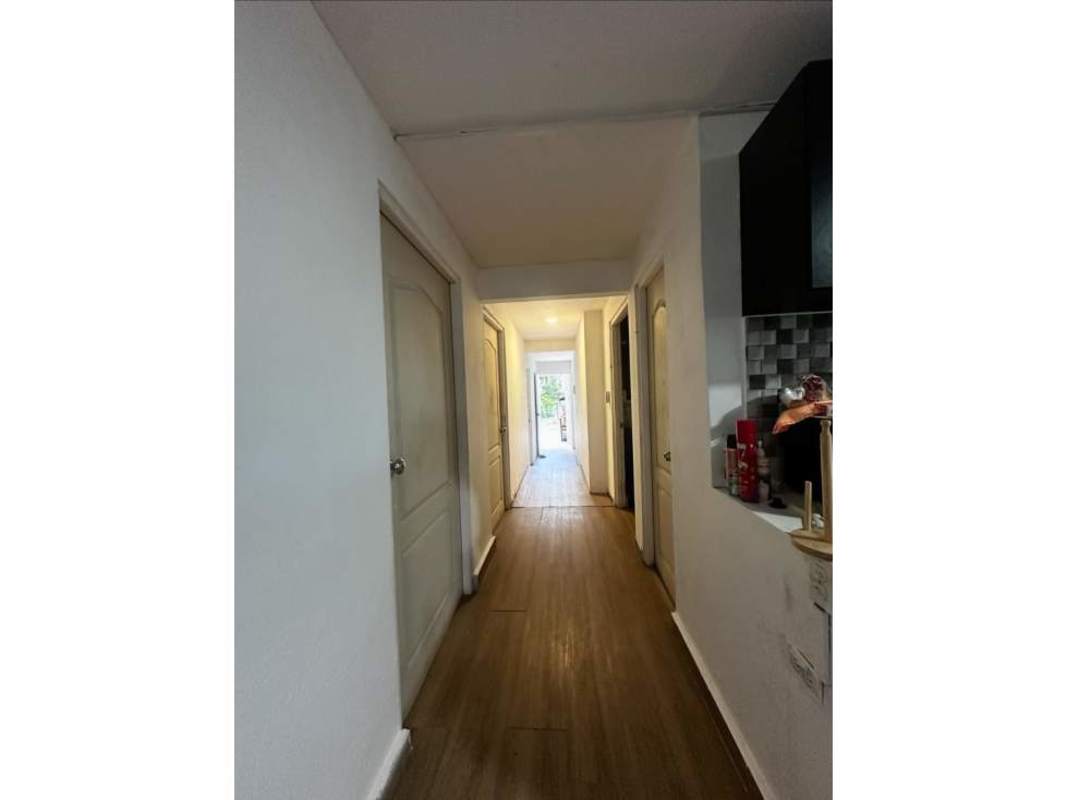 Long corridor and entry hallway with wood tiles leading to bedrooms in family house Ciudad Radial