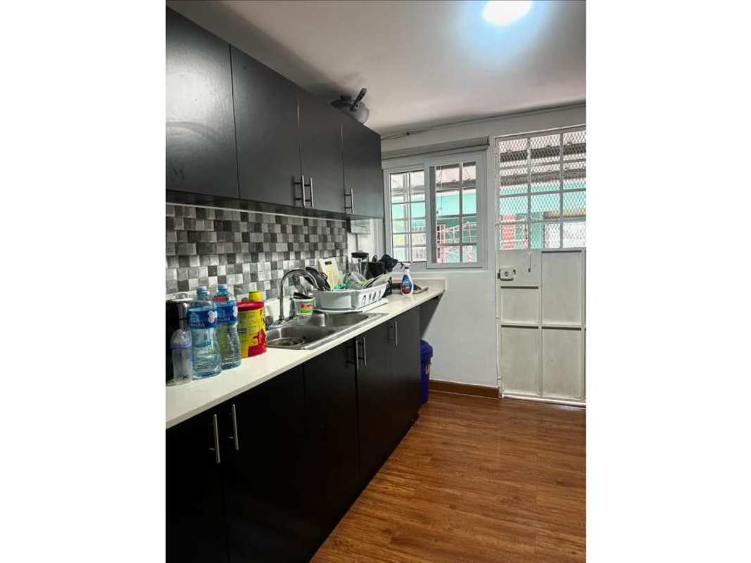 Modern kitchen with dark cabinets and tile backsplash in Ciudad Radial home for sale Panama