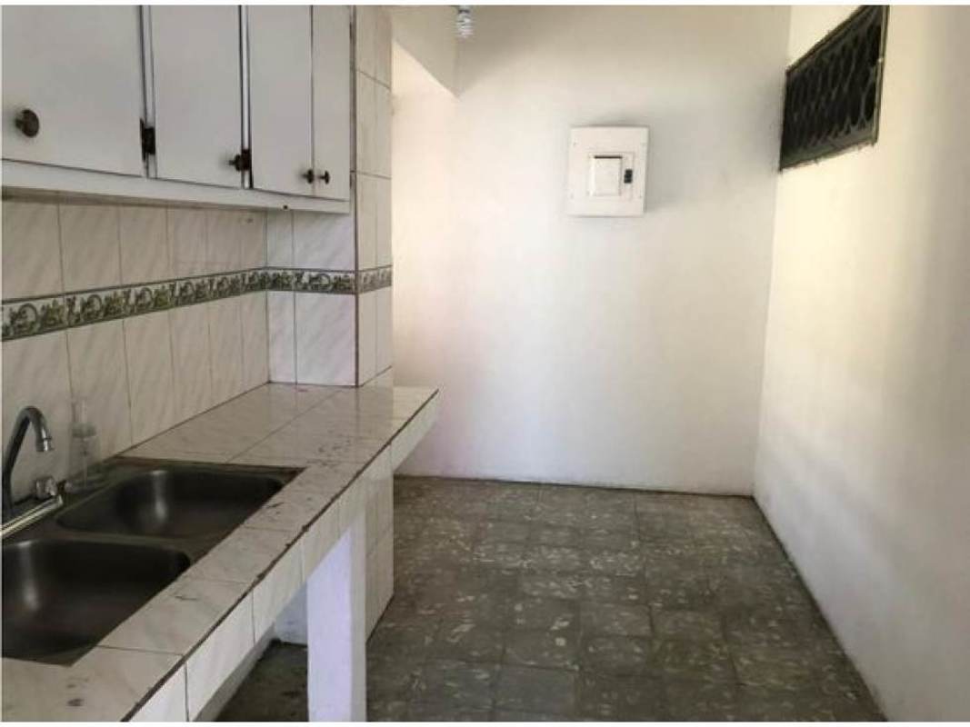 Basic kitchen white tile, cabinets, window PH Jardin Olímpico affordable condo Panama City