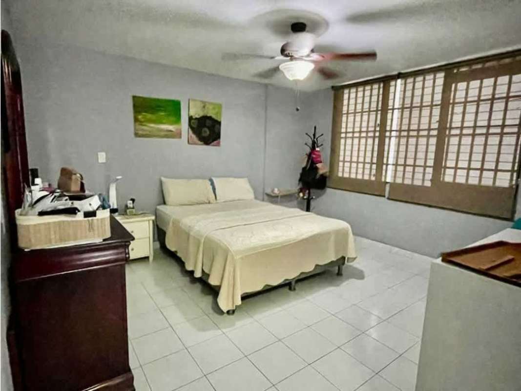 Bedroom featuring large window, built-in closet and tiled flooring in San Francisco apartment