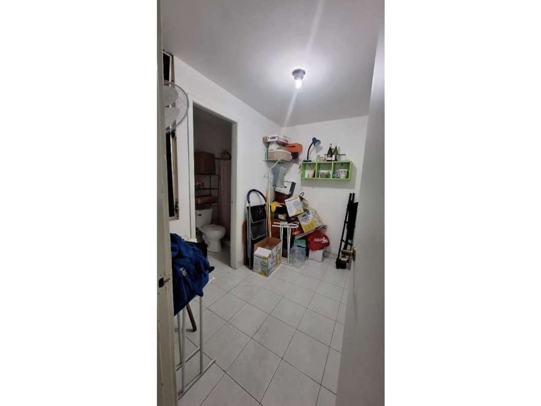 Compact utility area with storage, sink and attached small bathroom in Panama condo