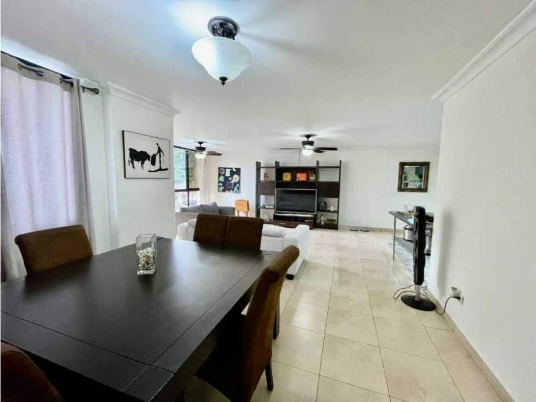 Spacious living room with natural light, ceiling fans, sliding windows in Panama apartment